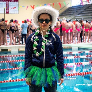 Girl in themed cowboy hat and lei